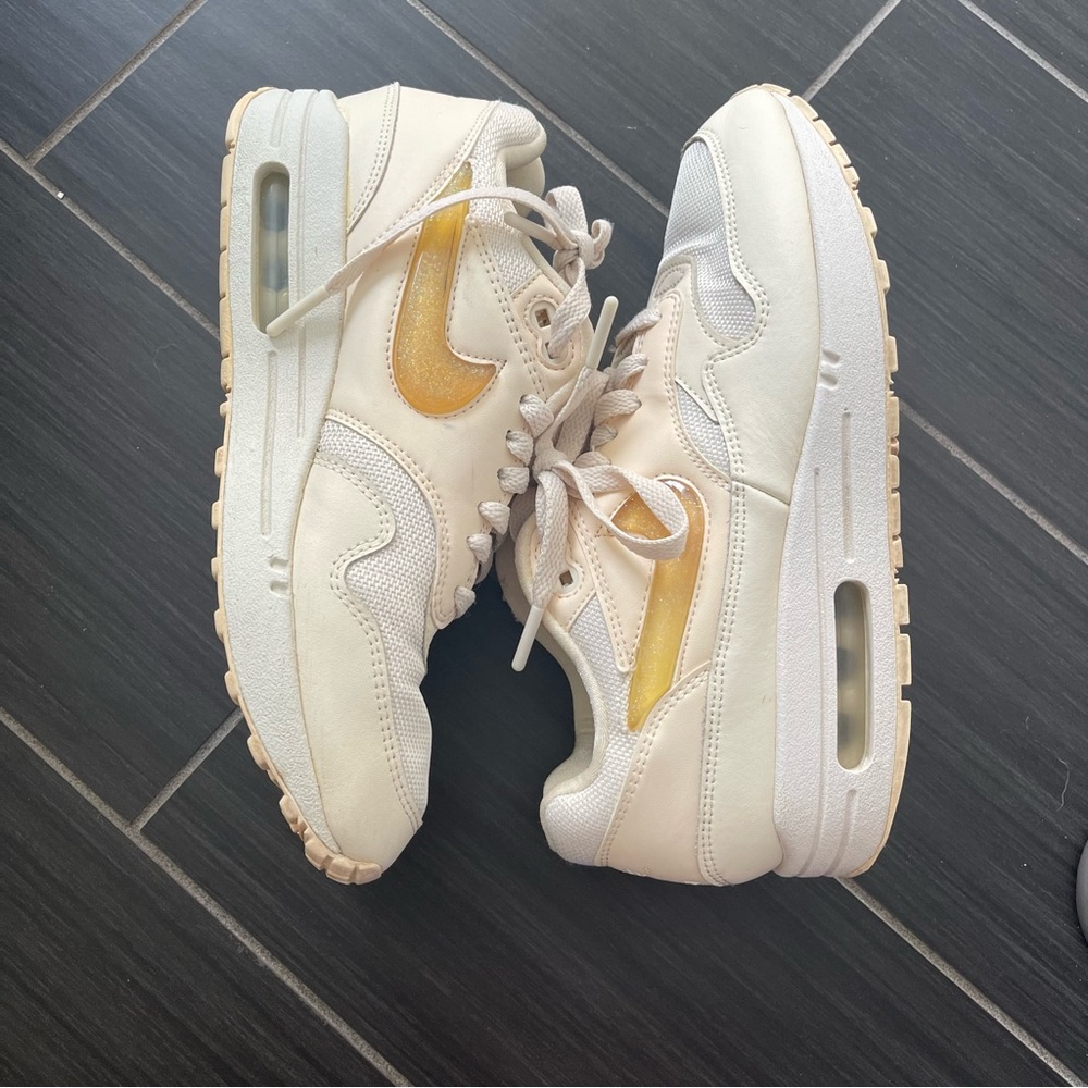 Nike Cream Sneakers with Yellow Swoosh Accent